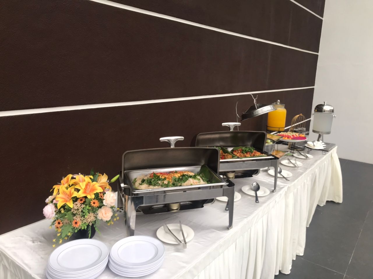 Twenty9 buffet setup with warm dishes, floral accents and refreshments